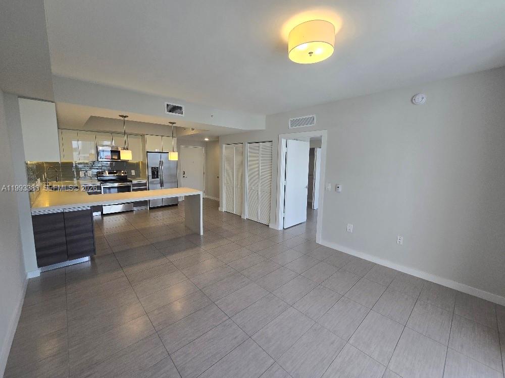117 Southwest 10th Street, Unit 2105 Miami, FL 33130 - Photo 12 of 18 a kitchen with a cabinets and appliances