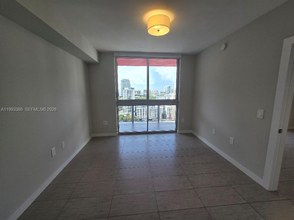 117 Southwest 10th Street, Unit 2105 Miami, FL 33130 - Photo 13 of 18 wooden floor in an empty room with a window
