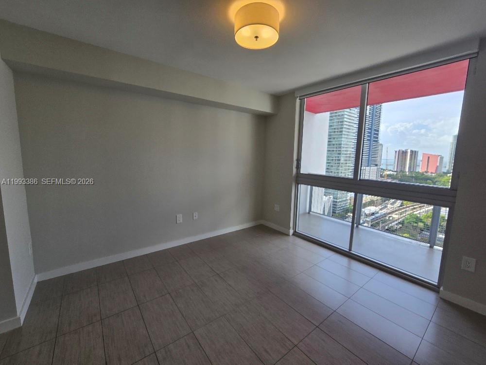 117 Southwest 10th Street, Unit 2105 Miami, FL 33130 - Photo 14 of 18 an empty room with windows