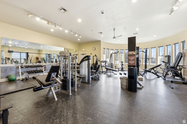 900 Bitner Road, Unit P17 Park City, UT 84098 - Photo 29 of 45 Spacious fitness center featuring track lighting, mirrored walls, rubberized flooring, an array of exercise equipment, and a curved wall of multiple windows