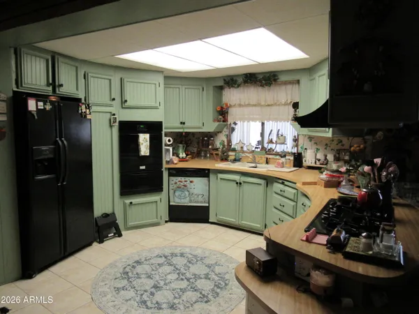 a kitchen with a sink cabinets and stainless steel appliances
