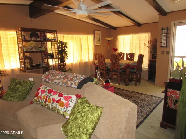 a living room with furniture dining table and a large window