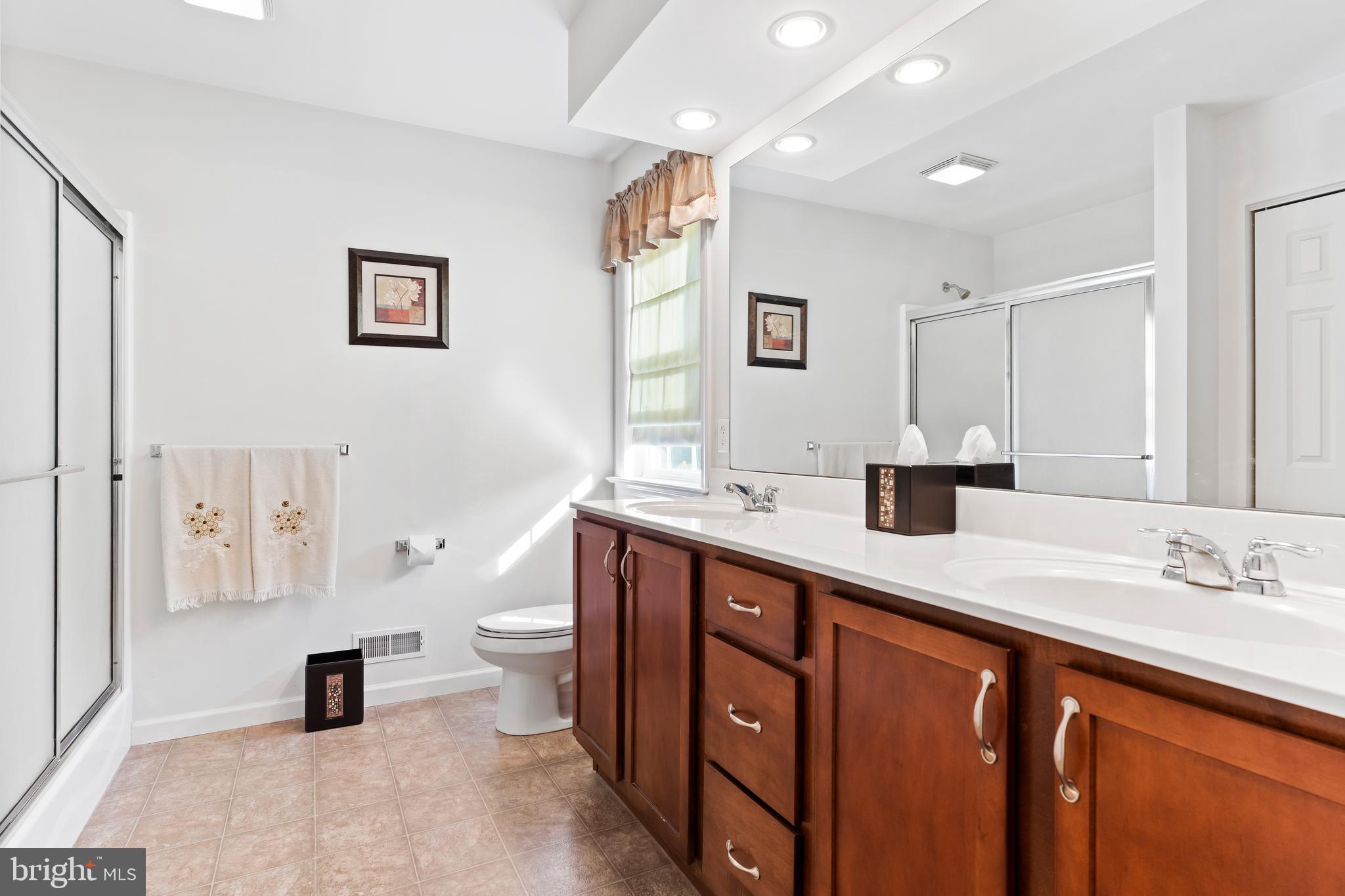 657 Hamaker Road Manheim, PA 17545 - Photo 26 of 41 a bathroom with a sink a toilet a mirror and shower