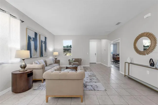a living room with furniture and a mirror