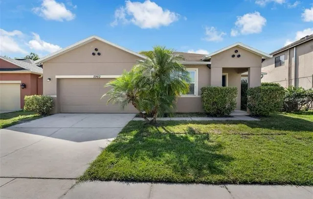 a large tree in front of a house
