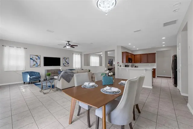 a large kitchen with stainless steel appliances granite countertop a refrigerator and a sink