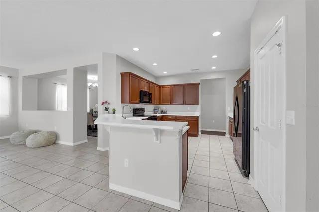 a kitchen with a sink refrigerator and cabinets
