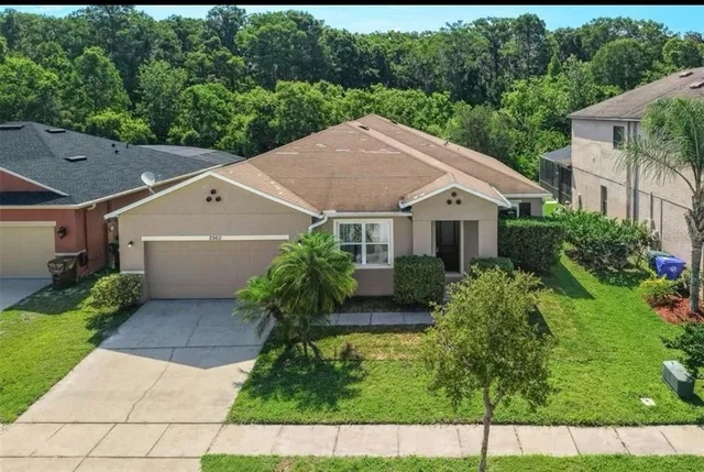 a aerial view of a house next to a yard
