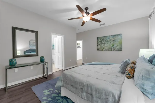 a view of a room with wooden floor and white walls