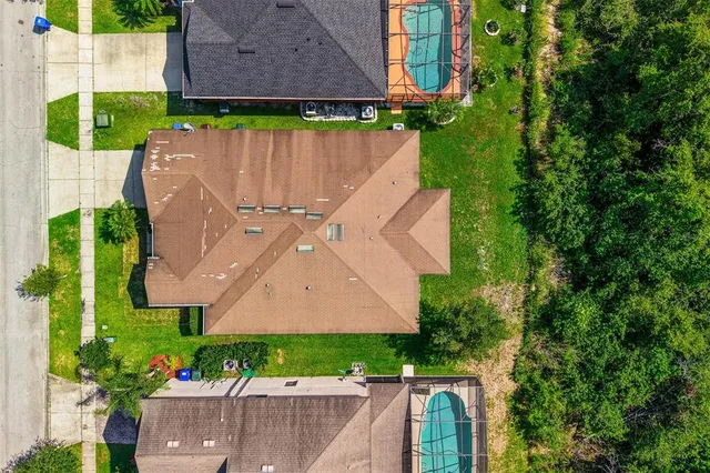 an aerial view of a house with a garden and swimming pool