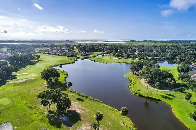 a view of a lake with houses in the background