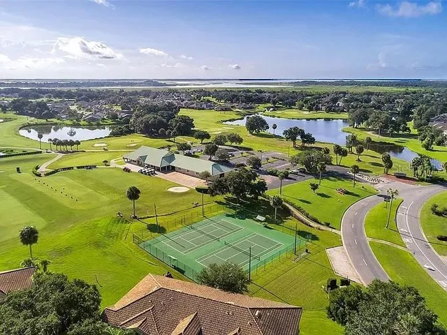 a view of a lake with houses in the back