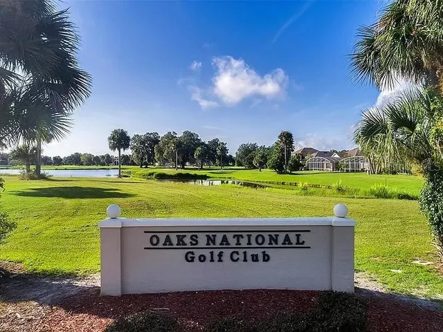 an aerial view of a house with a swimming pool and mountains