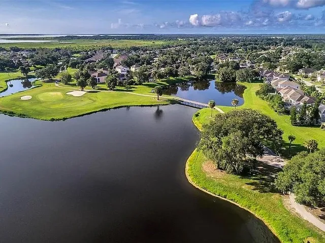 an aerial view of a city with lots of residential buildings and mountain view in back