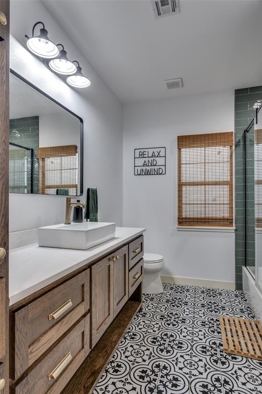 3120 Colcord Avenue Waco, TX 76707 - Photo 15 of 23 a bathroom with a sink a vanity and a mirror