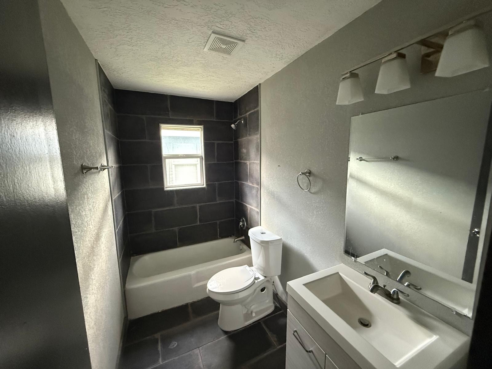 9045 Jutland Road Houston, TX 77033 - Photo 5 of 11 a bathroom with a sink toilet tub and shower