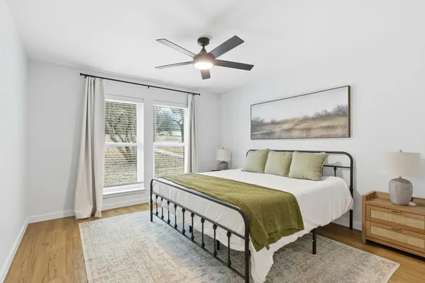 a bedroom with a large bed and a large window