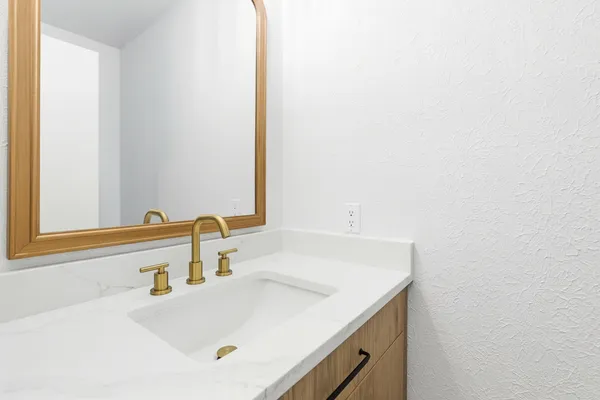 a bathroom with a sink and a mirror