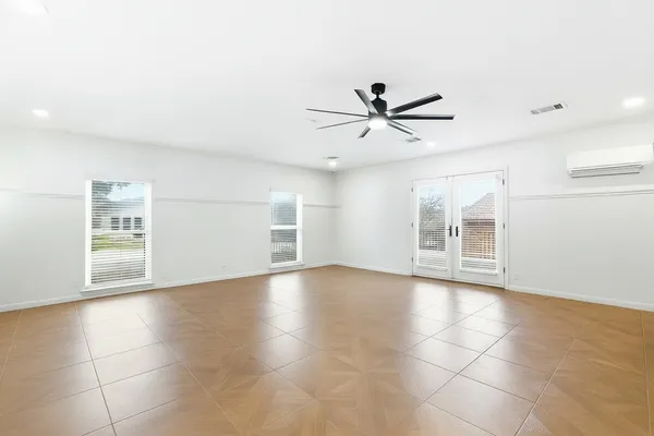 a large white kitchen with lots of counter space wooden floor and appliances
