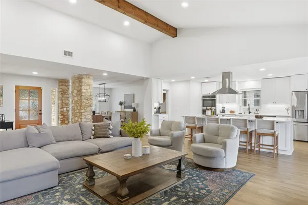 an aerial view of a house with swimming pool and mountains