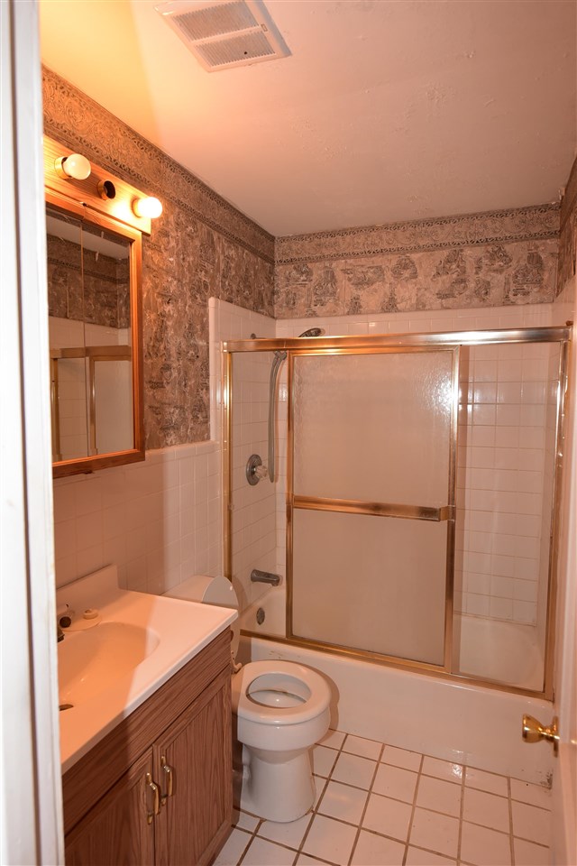 3282 Rochester Road Memphis, TN 38109 - Photo 12 of 21 a bathroom with a granite countertop sink toilet and shower