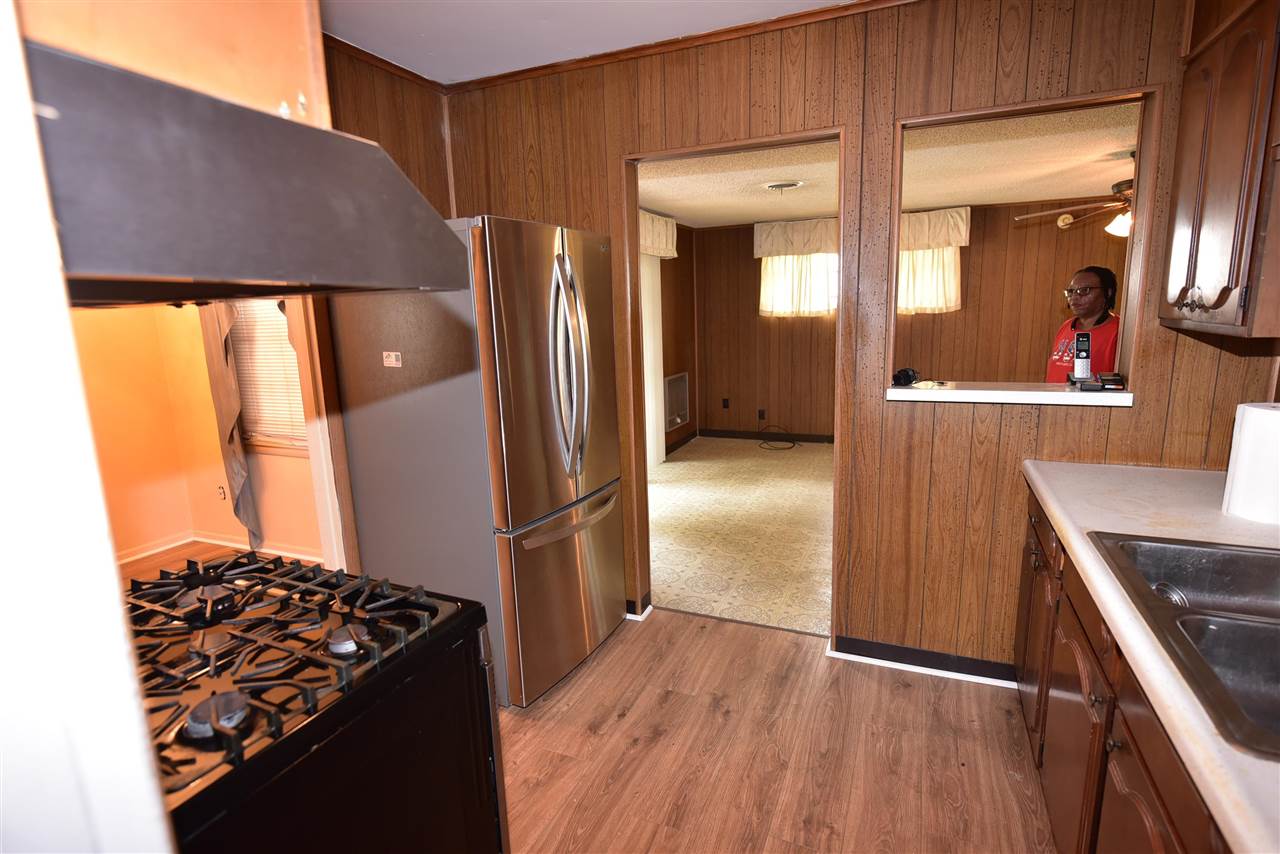 3282 Rochester Road Memphis, TN 38109 - Photo 14 of 21 a kitchen with stainless steel appliances granite countertop a refrigerator and a stove