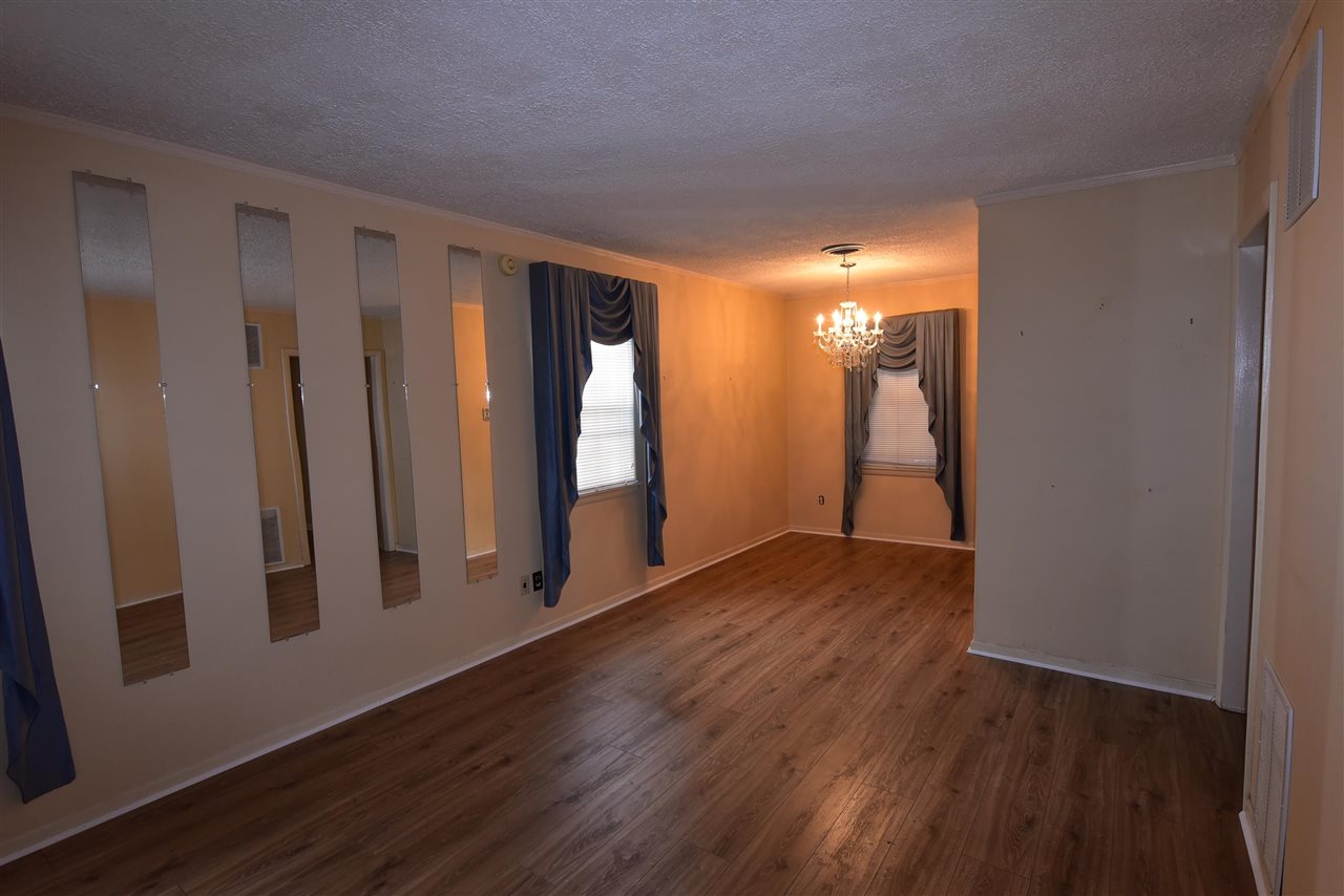 3282 Rochester Road Memphis, TN 38109 - Photo 4 of 21 a view of empty room with wooden floor and fan