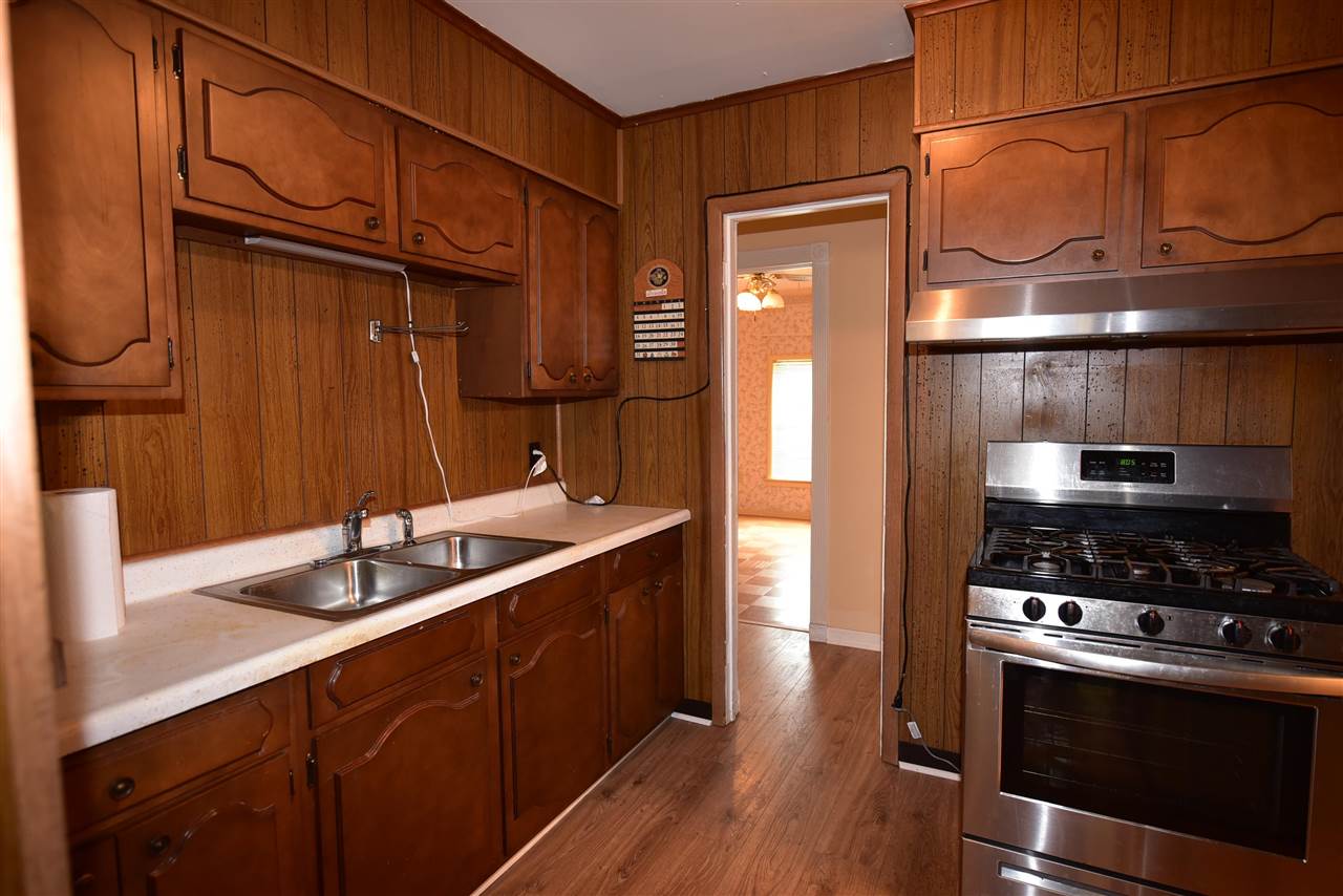 3282 Rochester Road Memphis, TN 38109 - Photo 6 of 21 a kitchen with stainless steel appliances granite countertop a sink stove and refrigerator