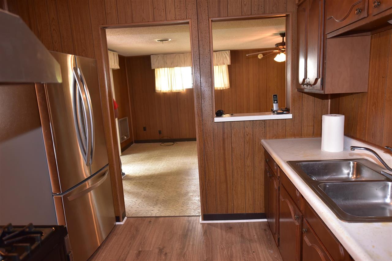 3282 Rochester Road Memphis, TN 38109 - Photo 7 of 21 a kitchen with granite countertop a refrigerator and a sink