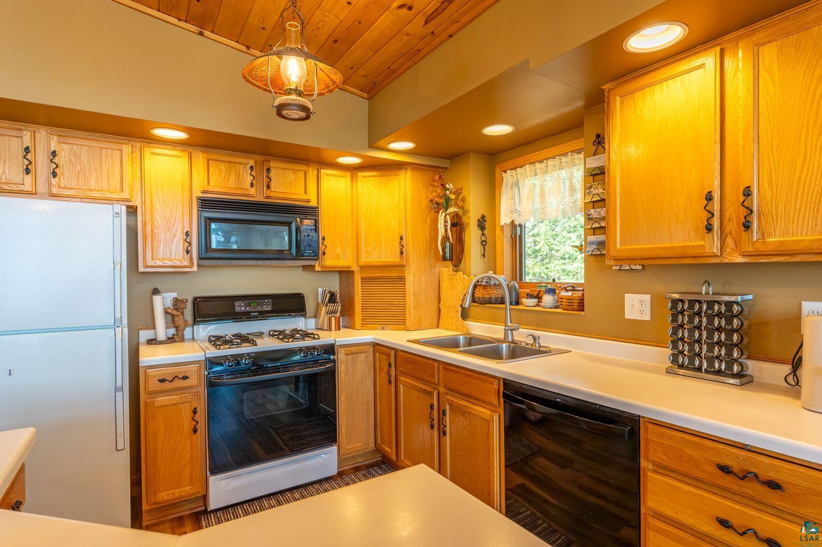 4452 Moccasin Point Road Tower, MN 55790 - Photo 11 of 44 Kitchen featuring natural wood cabinetry and a vaulted wood-finish ceiling