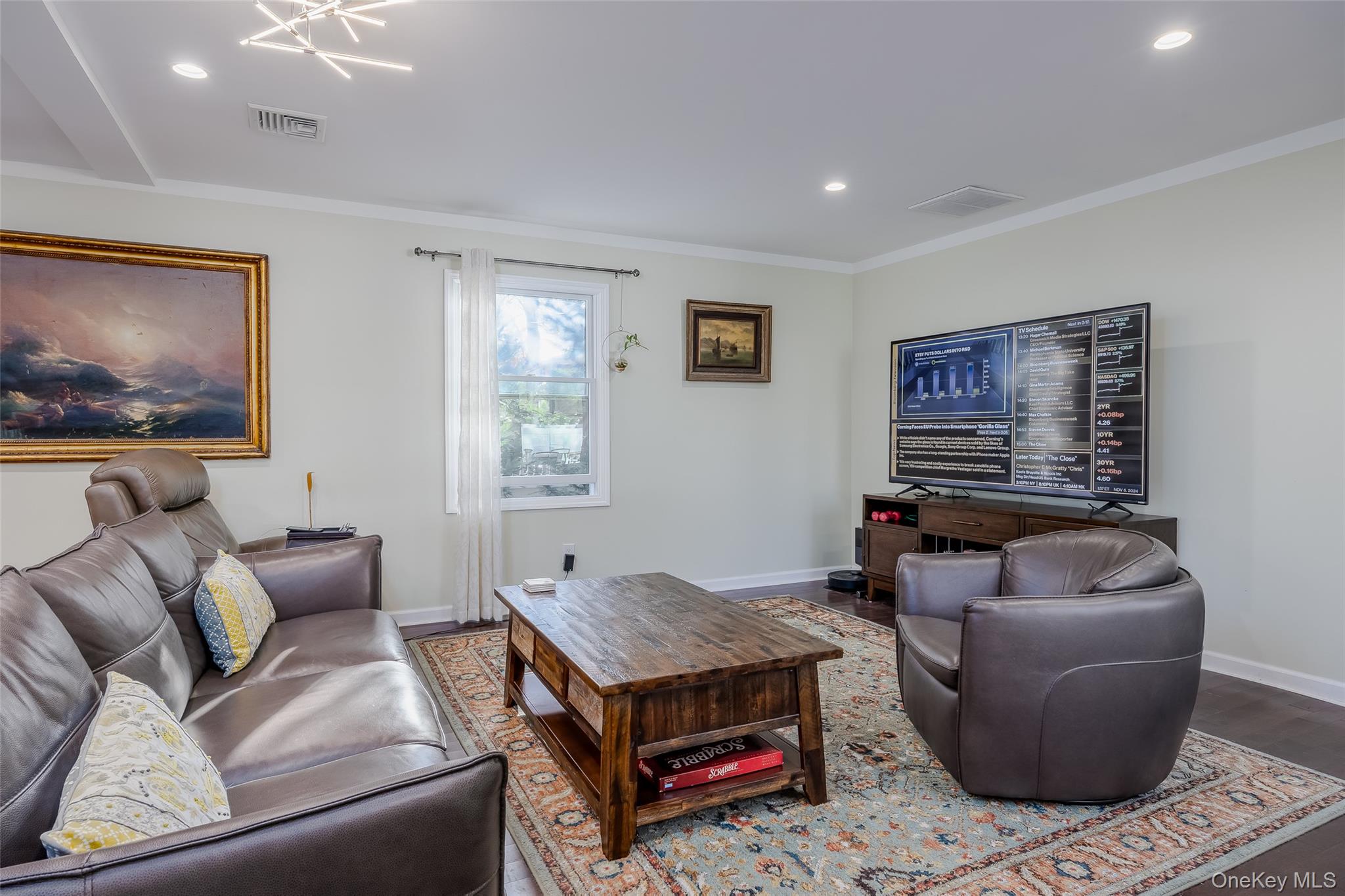 3 Earl Road Melville, NY 11747 - Photo 11 of 35 a living room with furniture and a flat screen tv