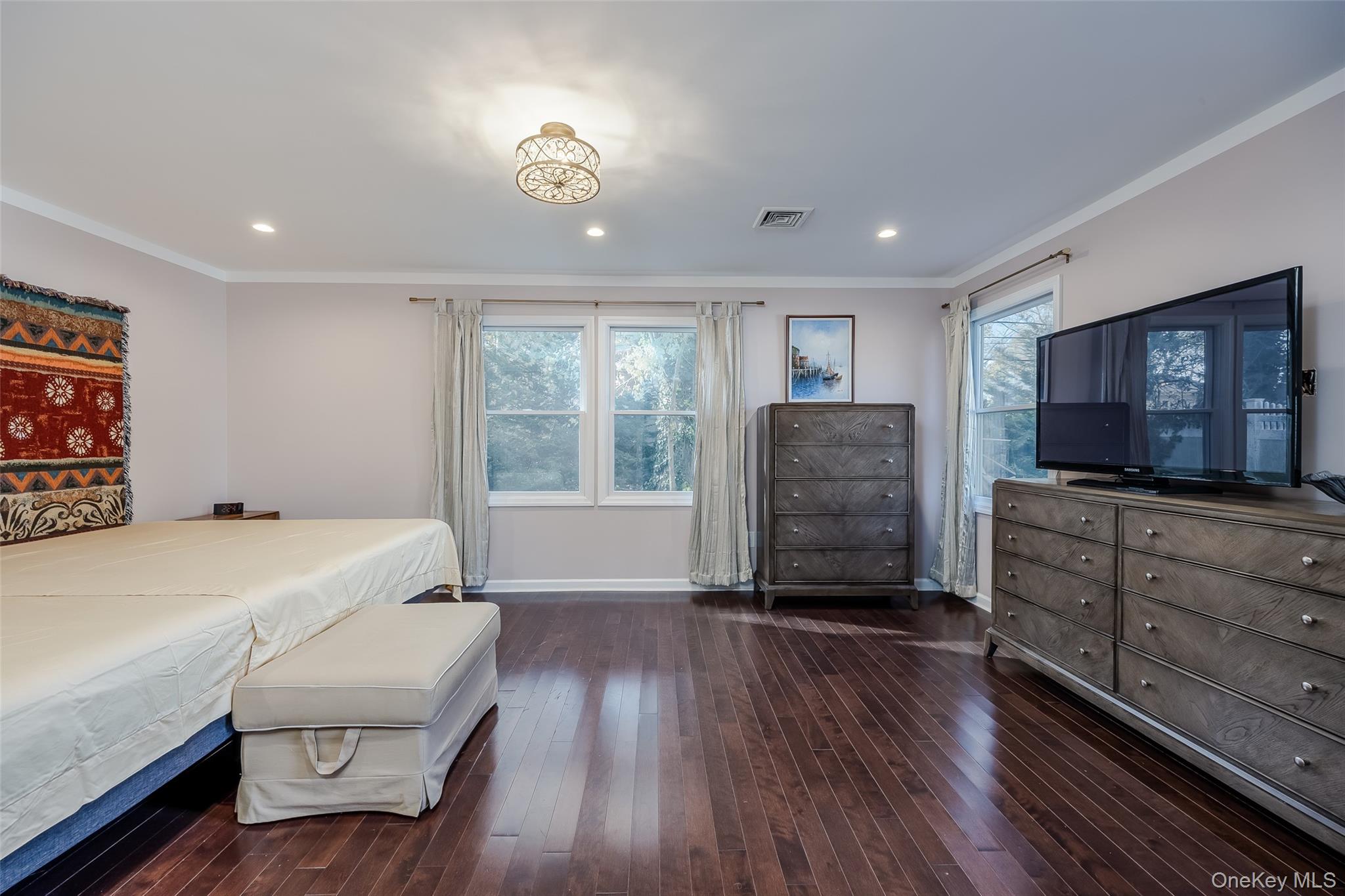 3 Earl Road Melville, NY 11747 - Photo 17 of 35 a bedroom with furniture and a flat screen tv