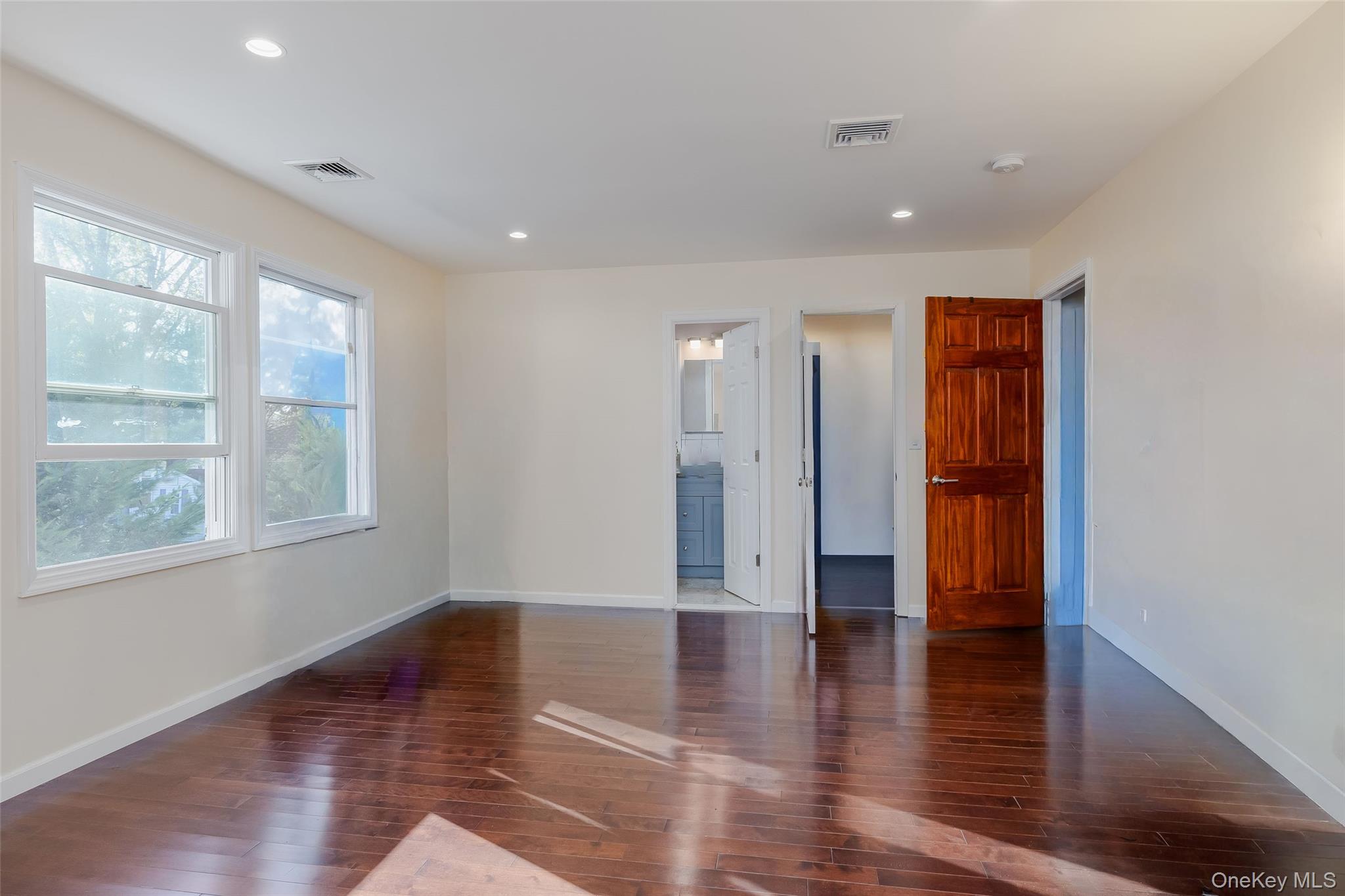 3 Earl Road Melville, NY 11747 - Photo 23 of 35 a view of an empty room with wooden floor and a window