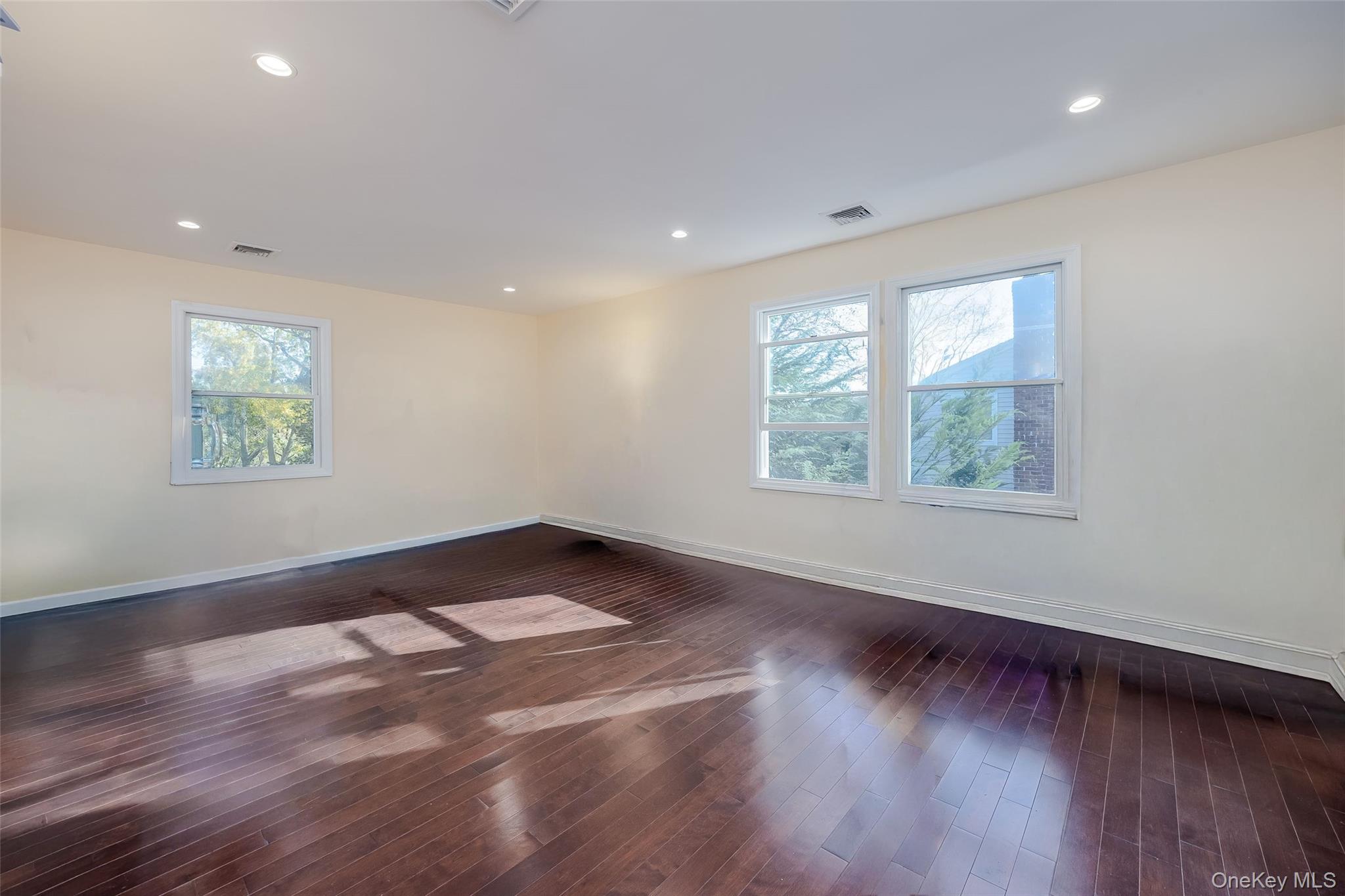 3 Earl Road Melville, NY 11747 - Photo 24 of 35 an empty room with wooden floor and windows