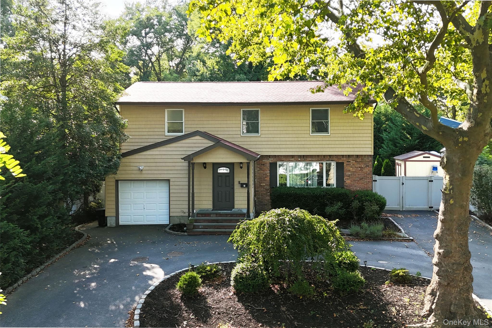 3 Earl Road Melville, NY 11747 - Photo 32 of 35 a view of a house with a yard plants and large tree