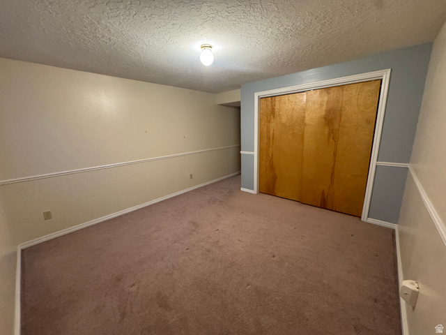 655 North 8th East Preston, ID 83263 - Photo 20 of 32 Unfurnished bedroom with a textured ceiling, carpet floors, and a closet