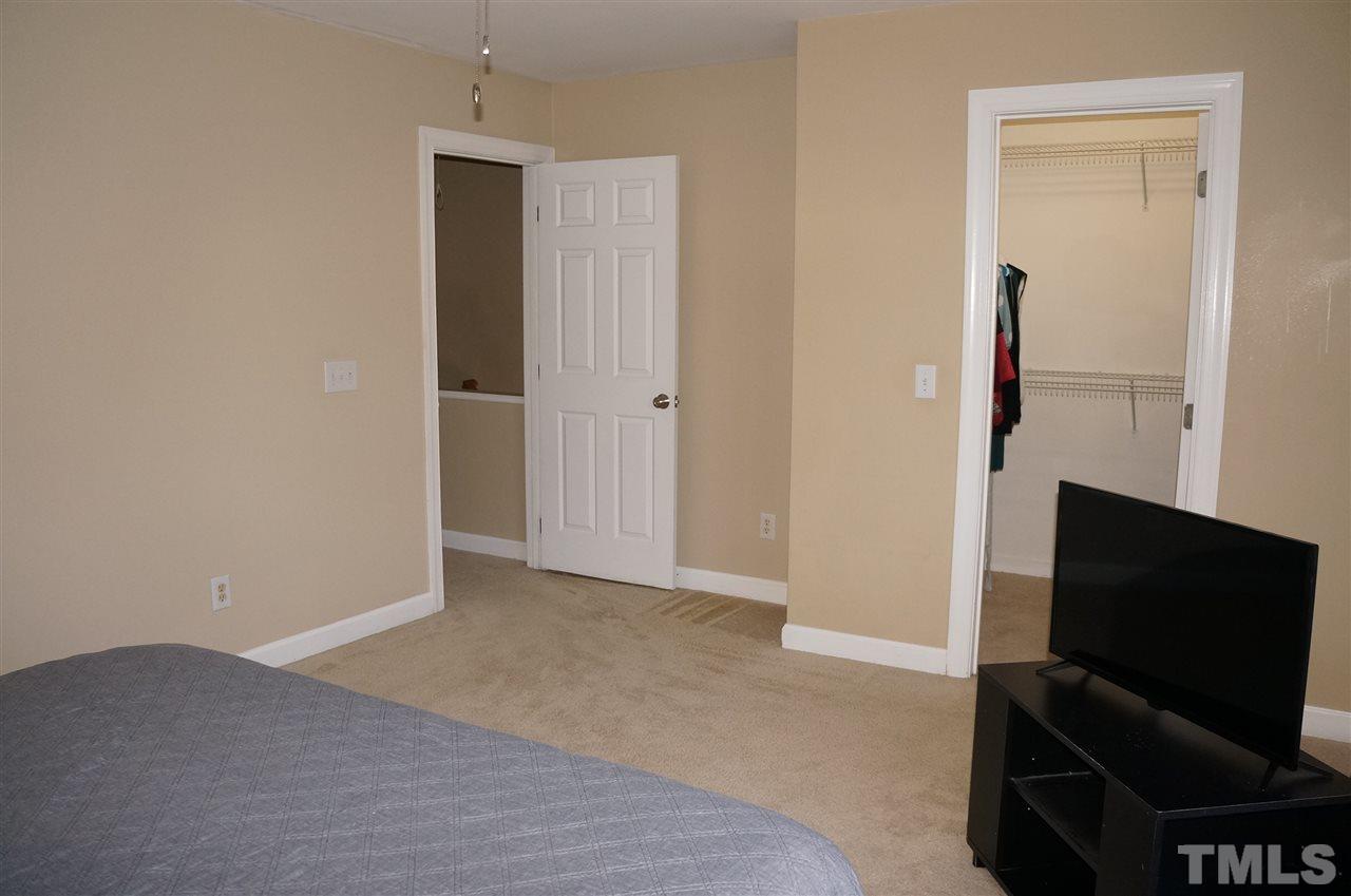 9204 Grassington Way Raleigh, NC 27615 - Photo 17 of 29 a livingroom with a flat screen tv and dresser