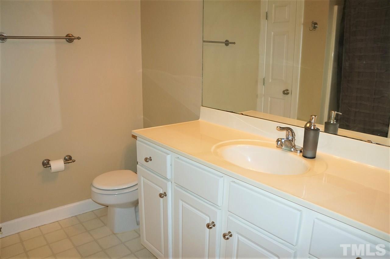 9204 Grassington Way Raleigh, NC 27615 - Photo 20 of 29 a bathroom with a sink and a toilet