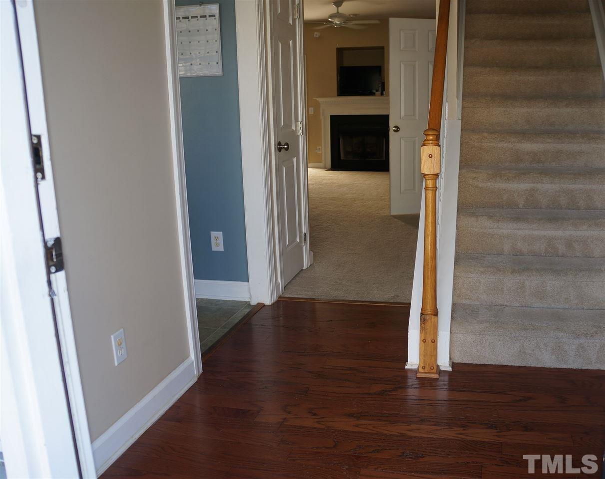 9204 Grassington Way Raleigh, NC 27615 - Photo 3 of 29 a view of a hallway with wooden floor