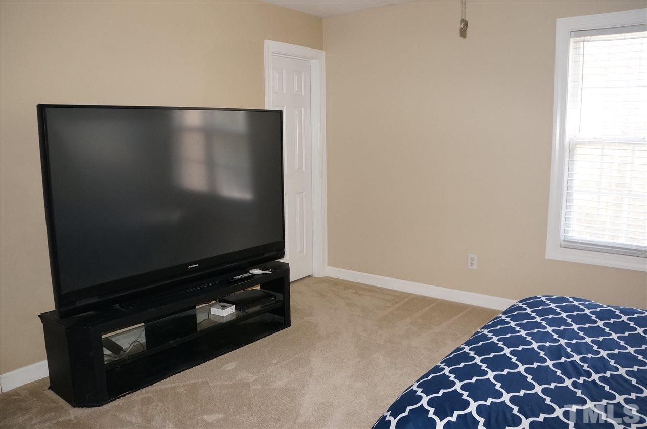 9204 Grassington Way Raleigh, NC 27615 - Photo 23 of 29 a living room with furniture and a flat screen tv