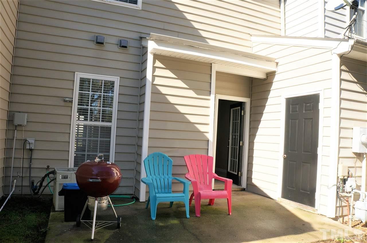 9204 Grassington Way Raleigh, NC 27615 - Photo 26 of 29 a backyard of a house with table and chairs