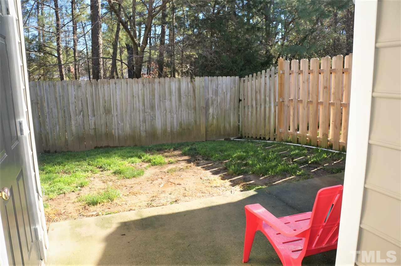 9204 Grassington Way Raleigh, NC 27615 - Photo 27 of 29 a backyard of a house with yard and tree