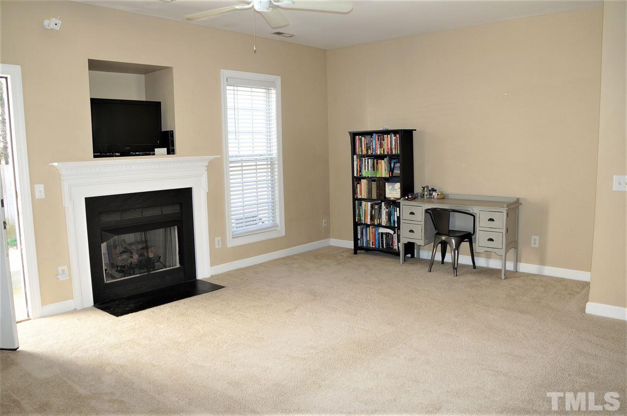 9204 Grassington Way Raleigh, NC 27615 - Photo 7 of 29 a living room with furniture and a fireplace