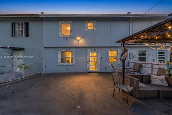 a front view of a house with outdoor seating