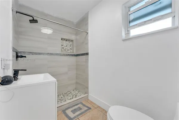 a bathroom with a toilet sink and shower