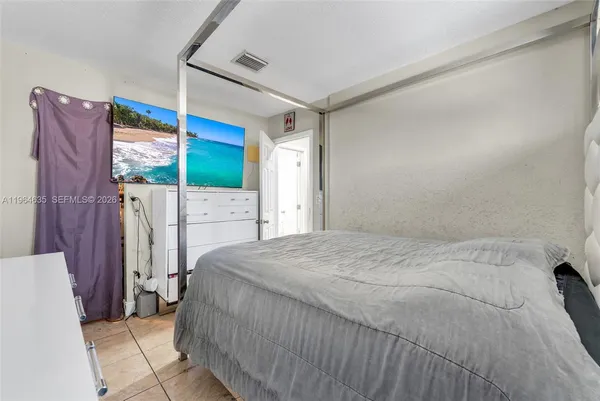 a bed sitting in a bedroom next to a window