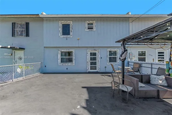 a backyard of a house with outdoor seating