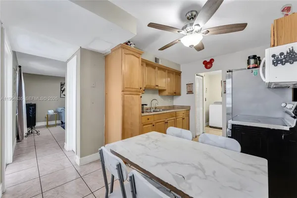 a kitchen with cabinets and refrigerator