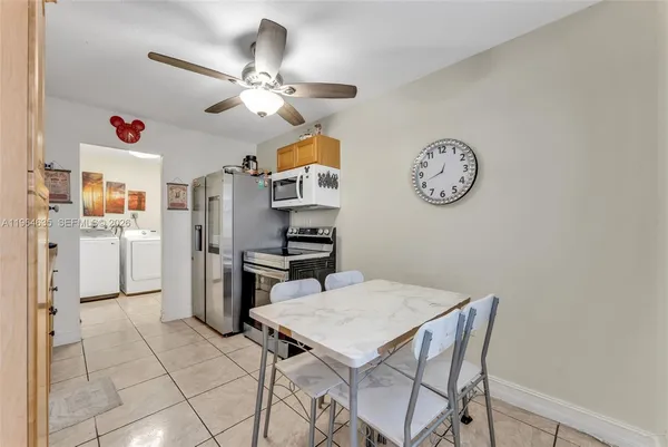 a view of a kitchen with a dining table and chairs