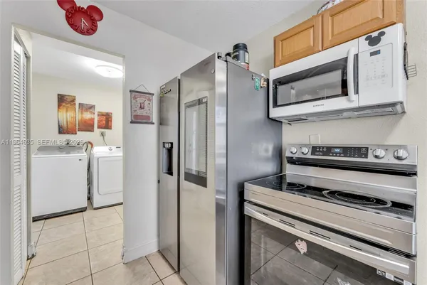 a kitchen with stainless steel appliances a refrigerator stove and cabinets